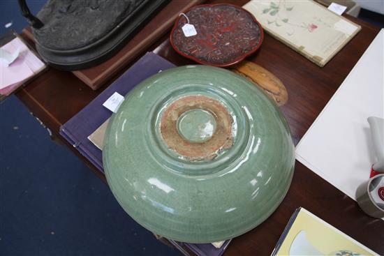 A Chinese Ming dynasty Longquan celadon dish, 15th century, d. 45cm, hongmu stand,